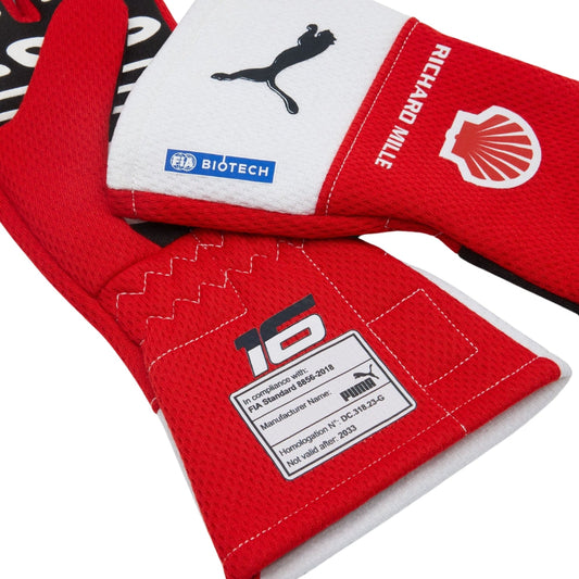 Red and white Charles Leclerc F1 racing gloves with various logos on a white background