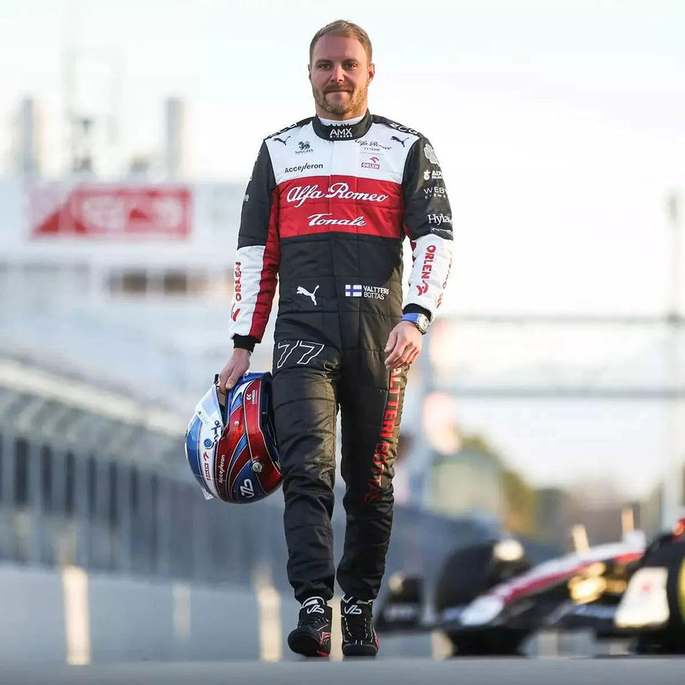 Valtteri Bottas in a 2022 F1 racing suit holding a helmet on a track with blurred background