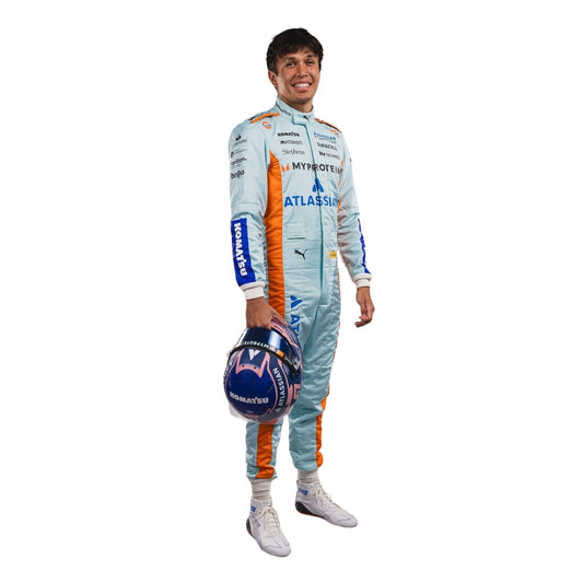 Alexander Albon wearing an F1 racing suit in 2025 Sao Paul GP with various sponsor logos on a white background