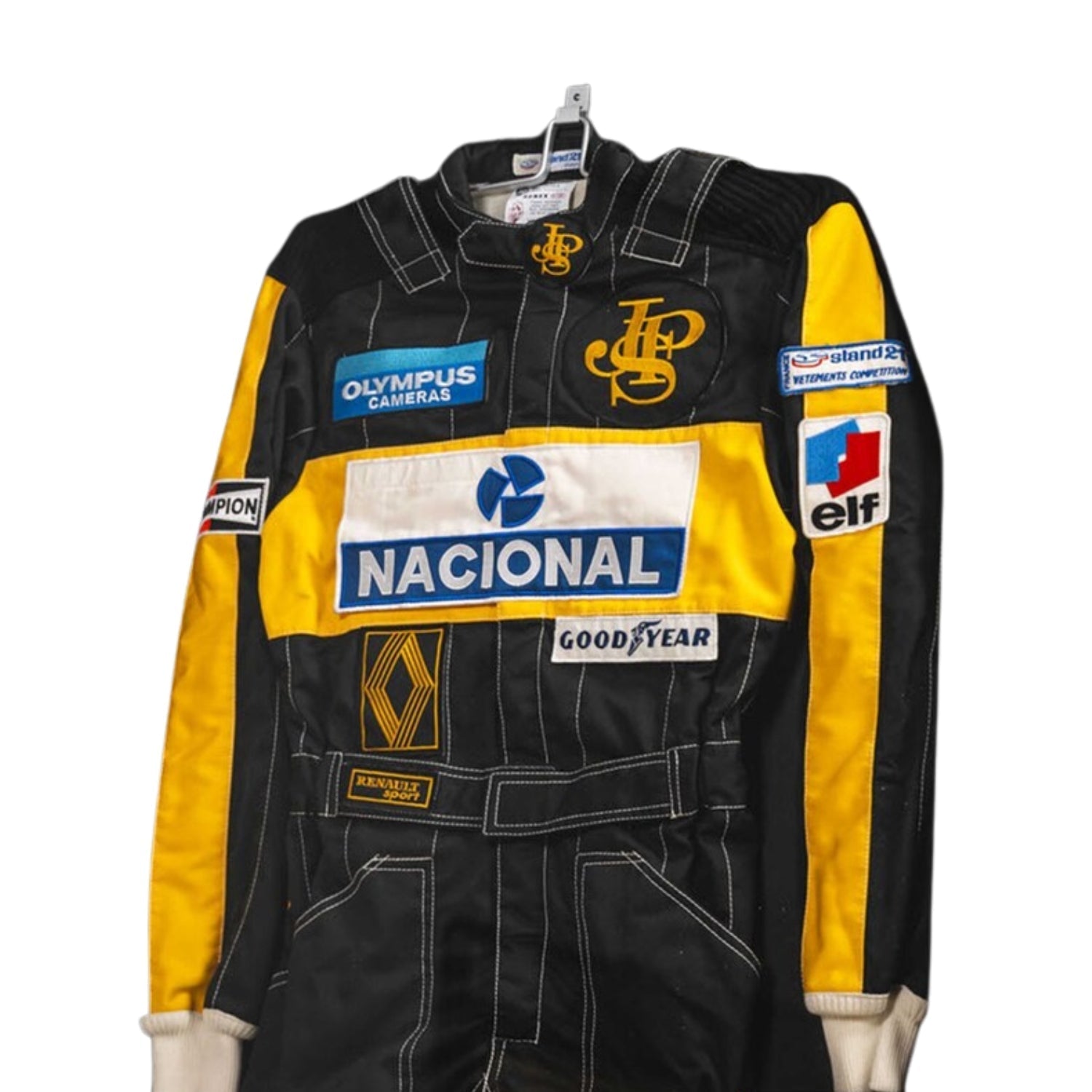 Close-up detail of the Ayrton Senna 1985 F1 racing suit fabric and stitching, showcasing vintage craftsmanship and sponsor detailing.