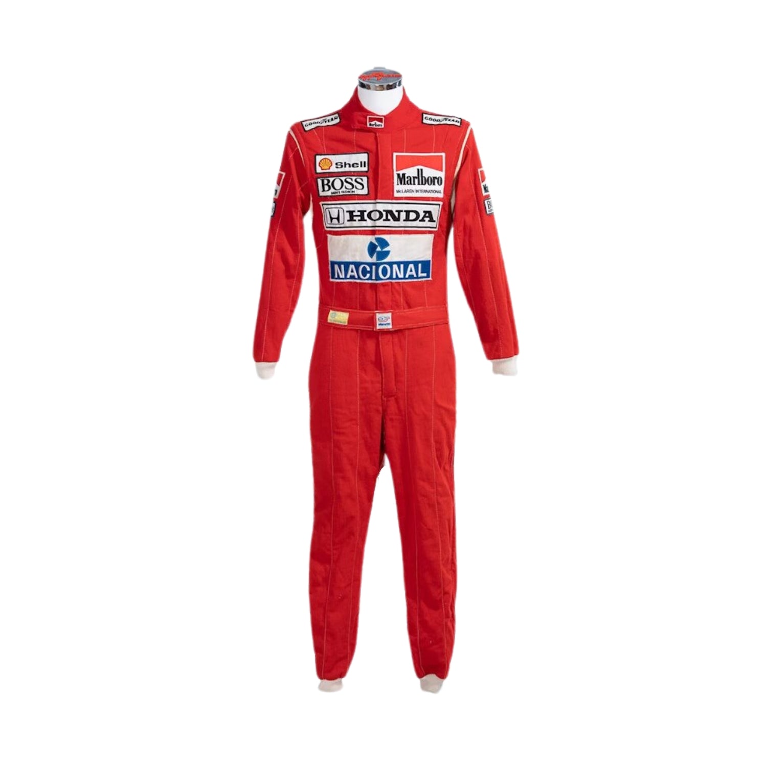 Front view of Ayrton Senna’s 1988 Stand21 F1 racing suit in bright red with white panels and detailed sponsor patches, worn during his championship-winning season.