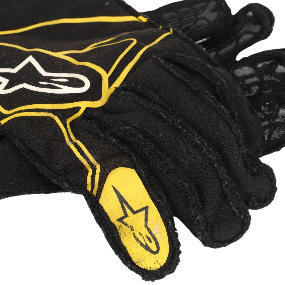 Black Carlos Sainz 2017 F1 Racing gloves with yellow accents and a star logo on a white background