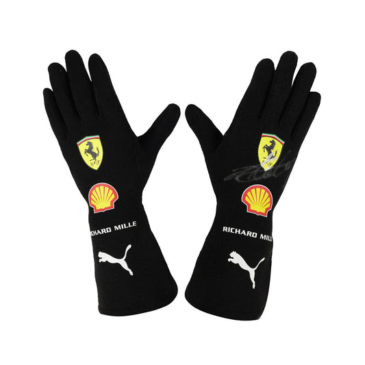 Black Charles Leclerc 2022 F1 racing gloves with Ferrari, Shell, and Puma logos on a white background