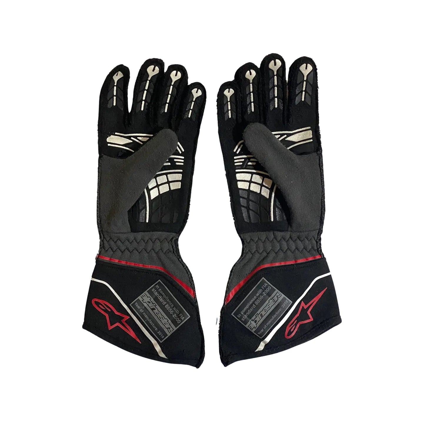 Pair of black Conor Daly 2018 NASCAR racing gloves with red accents on a white background