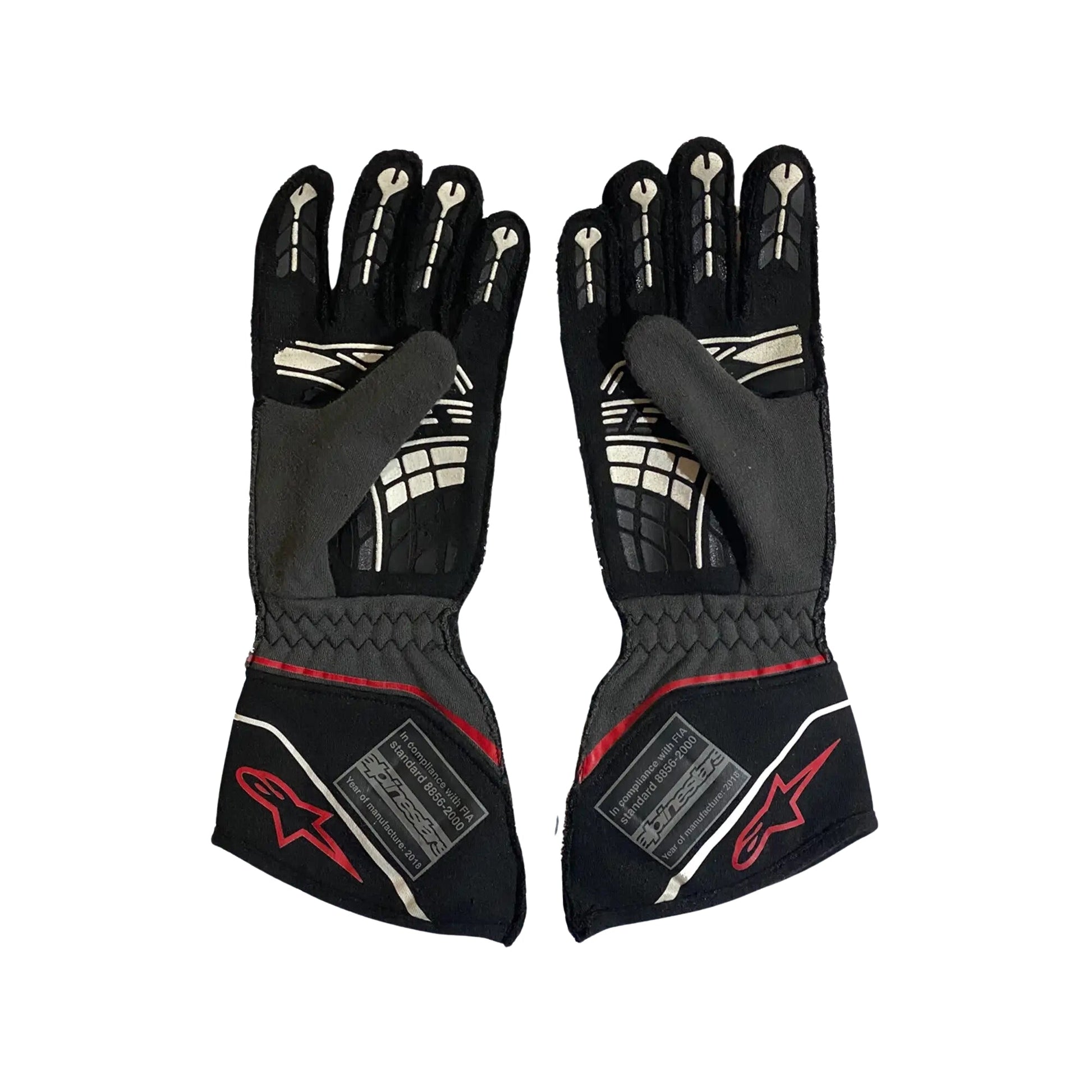 Pair of black Conor Daly 2018 NASCAR racing gloves with red accents on a white background
