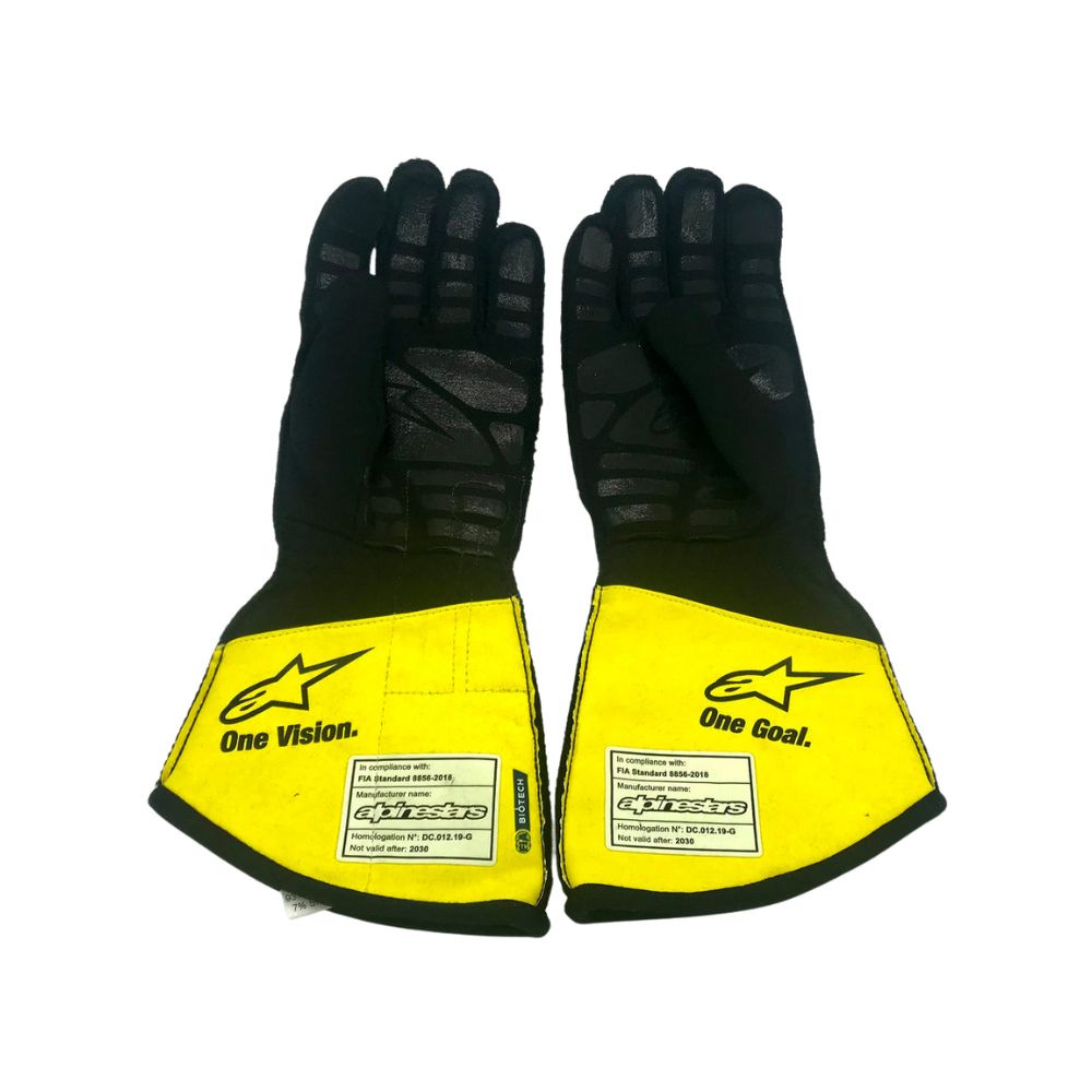 Pair of black and yellow Lance Stroll 2020 F1 Racing gloves with visible branding on a white background