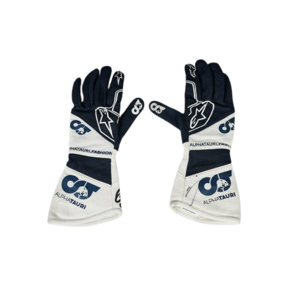 Pair of black and white Daniel Ricciardo 2023 F1 Racing gloves with AlphaTauri branding on a white background