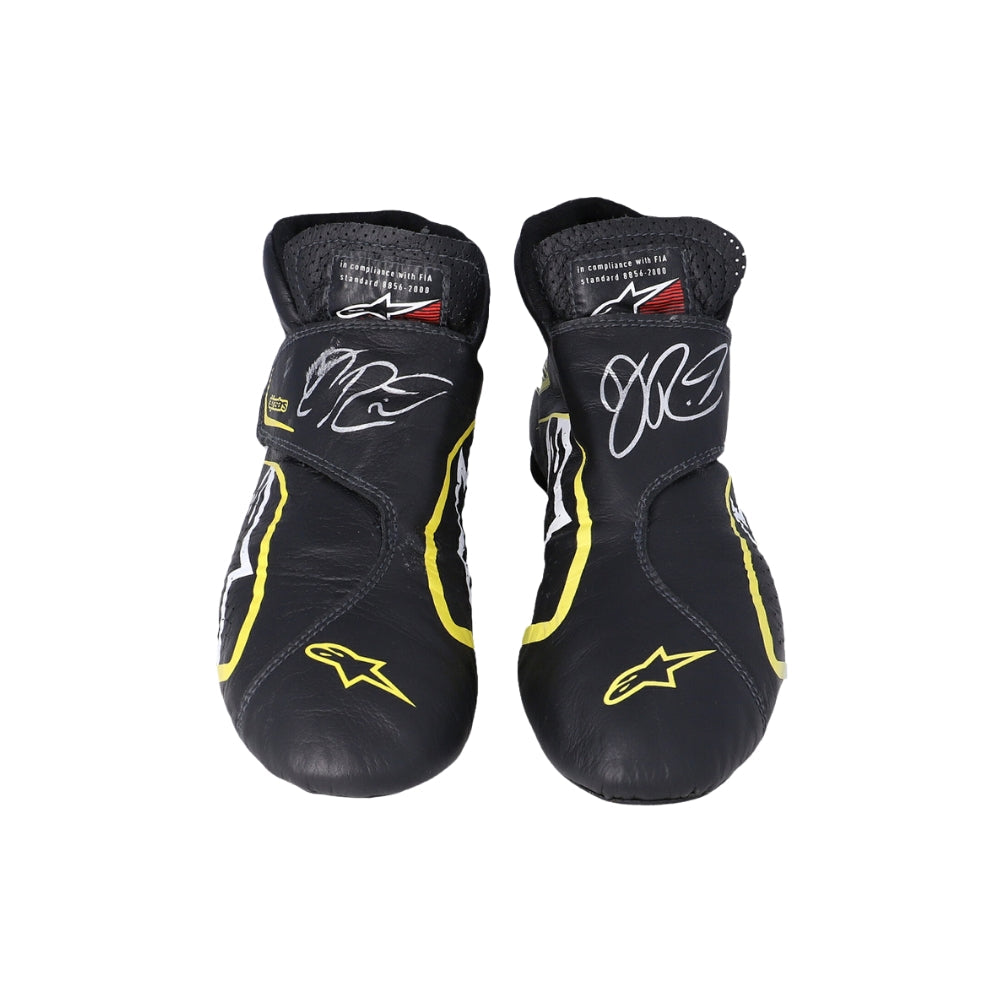 Pair of black and yellow Daniel Ricciardo 2019 Race Worn F1 racing boots with branding on a white background