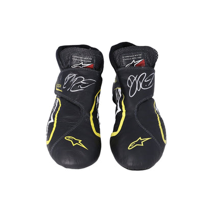 Pair of black and yellow Daniel Ricciardo 2019 Race Worn F1 racing boots with branding on a white background