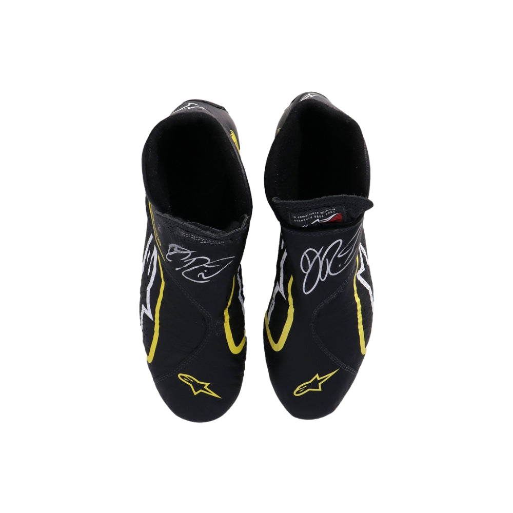 Black Daniel Ricciardo 2019 Race Worn F1 racing shoes with yellow accents on a white background