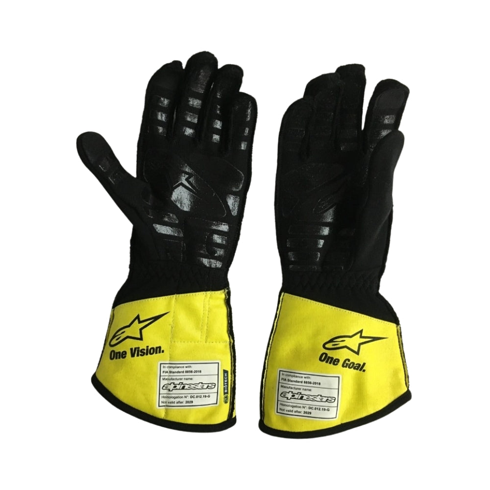 Pair of Esteban Ocon 2020 F1 black and yellow gloves with Renault branding on a white background