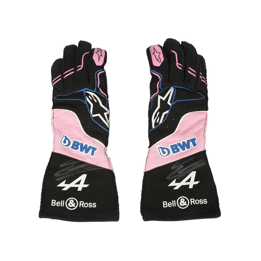 Pair of black and pink Esteban Ocon 2023 Miami GP F1 Racing gloves with branding on a white background