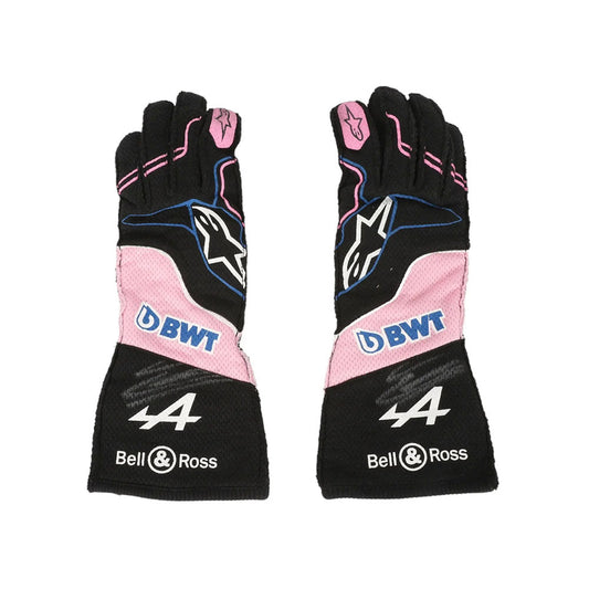 Pair of black and pink Esteban Ocon 2023 Miami GP F1 Racing gloves with branding on a white background