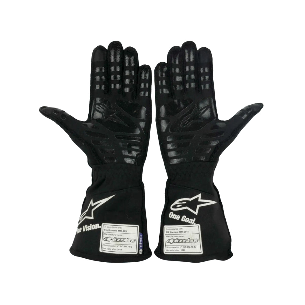 Pair of black Fernando Alonso 2021 F1 racing gloves with visible branding on a white background