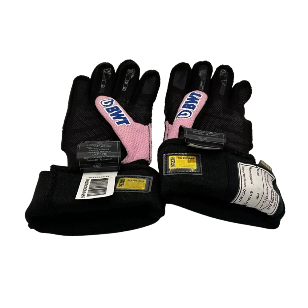 Pair of black Fernando Alonso 2022 F1 Racing gloves with pink interior and visible branding on a white background
