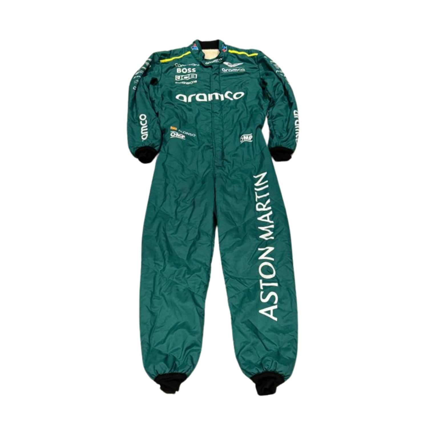 Fernando Alonso standing confidently in his 2024 Formula 1 racing suit, front view showcasing a deep green base with contrasting black panels and subtle silver detailing along the chest and arms.