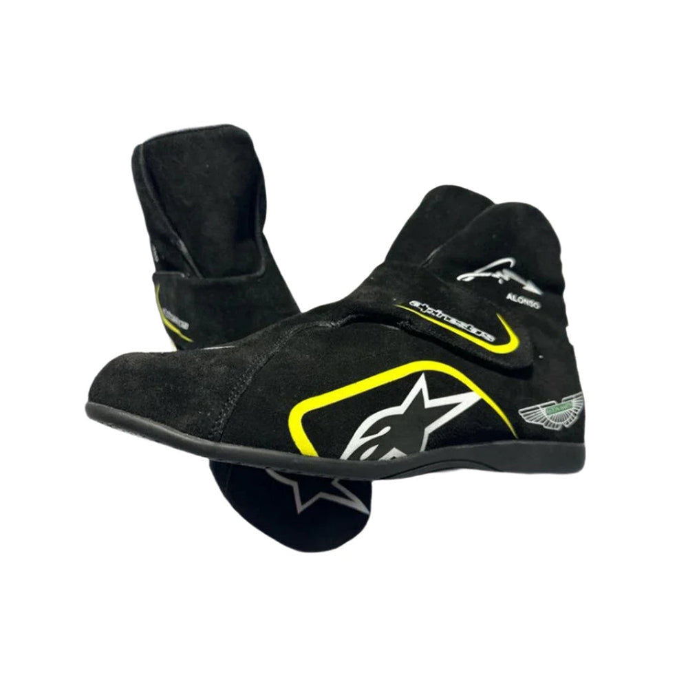 Black Fernando Alonso Aston Martin 2023 F1 racing boots with yellow accents on a white background