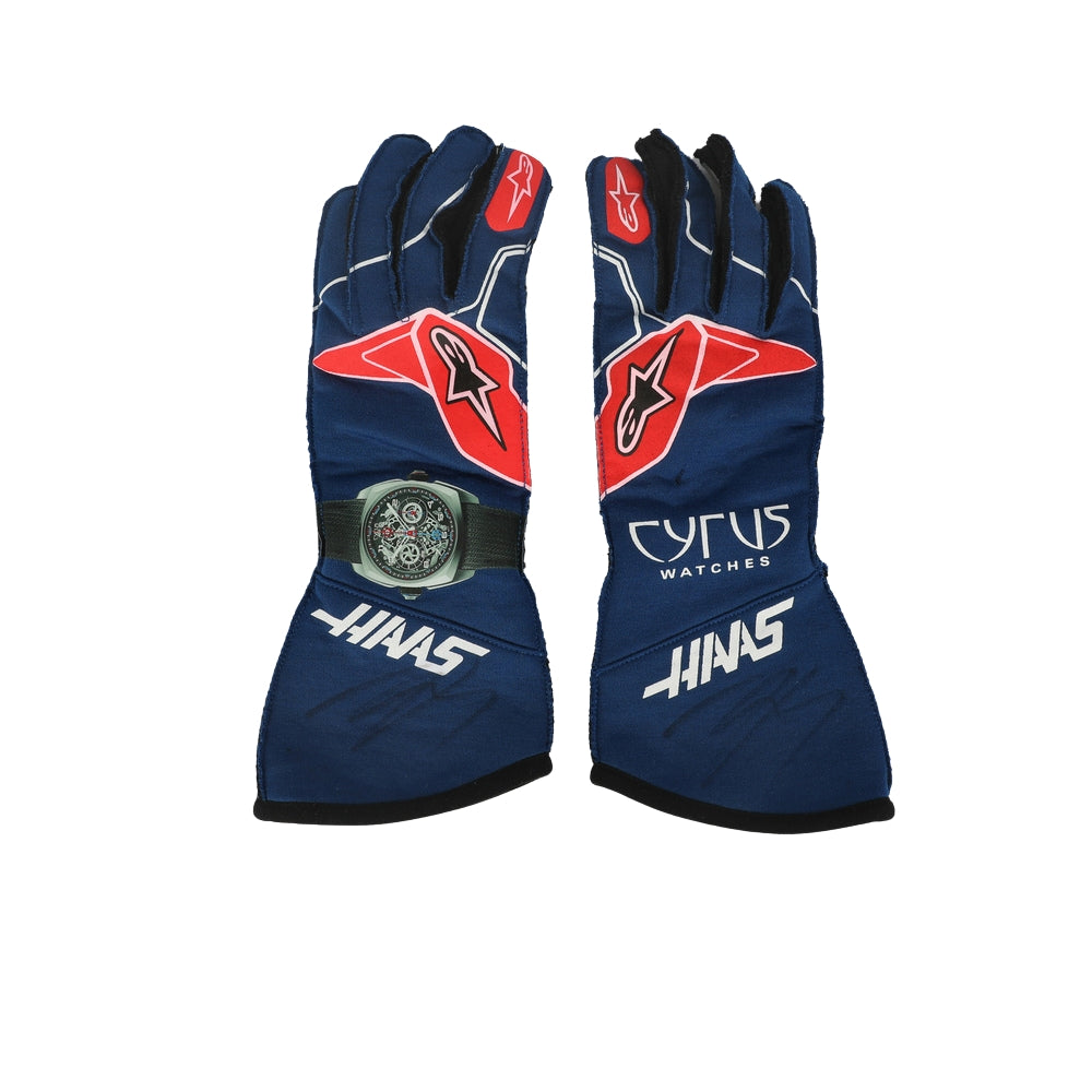 Pair of blue Kevin Magnussen 2022 F1 racing gloves with red and white accents on a white background