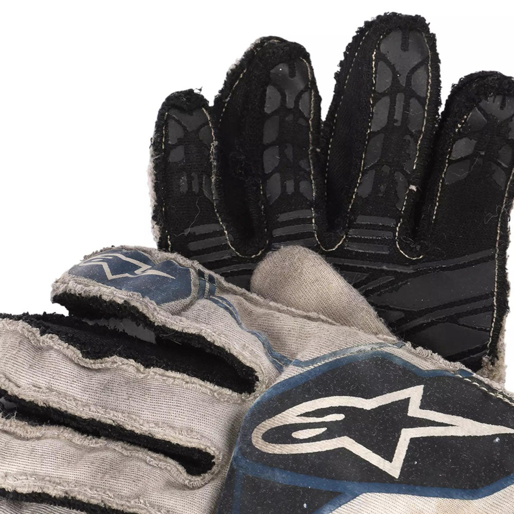 Close-up of a black and gray Lance Stroll 2017 F1 Racing glove with a brand logo on a white background