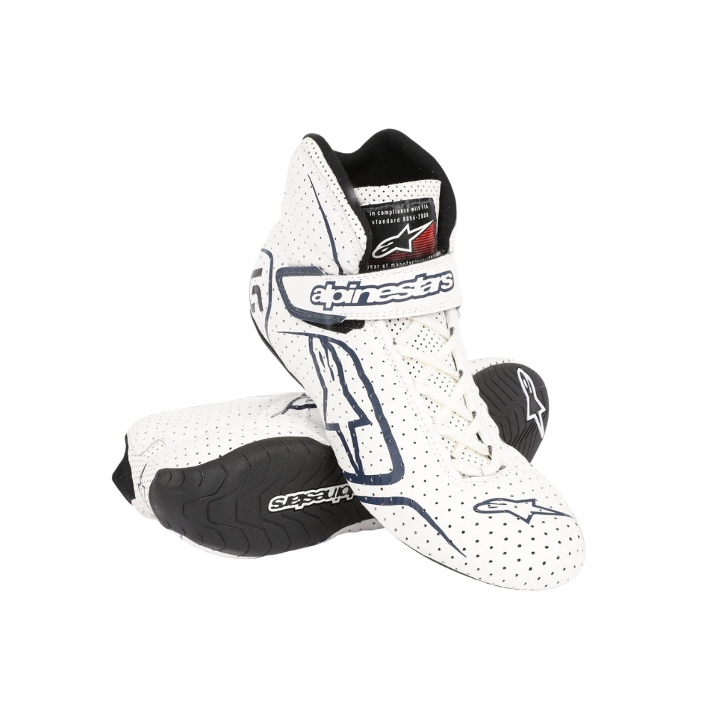 White Lance Stroll 2017 F1 racing boots with black soles on a white background, featuring Alpinestars branding.