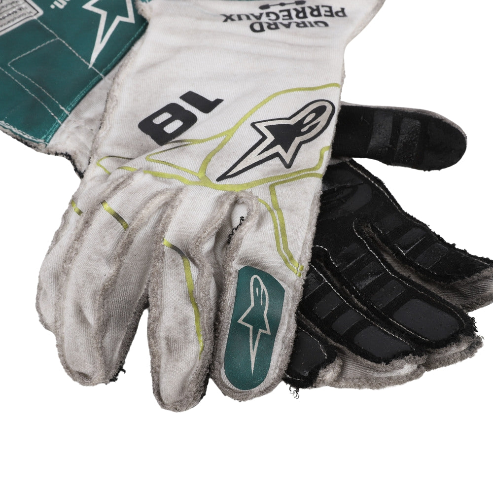 Close-up of a Lance Stroll 2022 Dutch GP white and black F1 racing gloves with branding on a white background