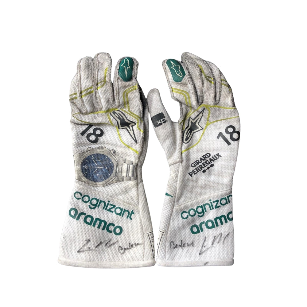 Pair of Lance Stroll 2023 Baku Worn F1 racing gloves with sponsor logos on a white background