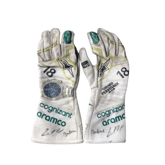 Pair of Lance Stroll 2023 Baku Worn F1 racing gloves with sponsor logos on a white background