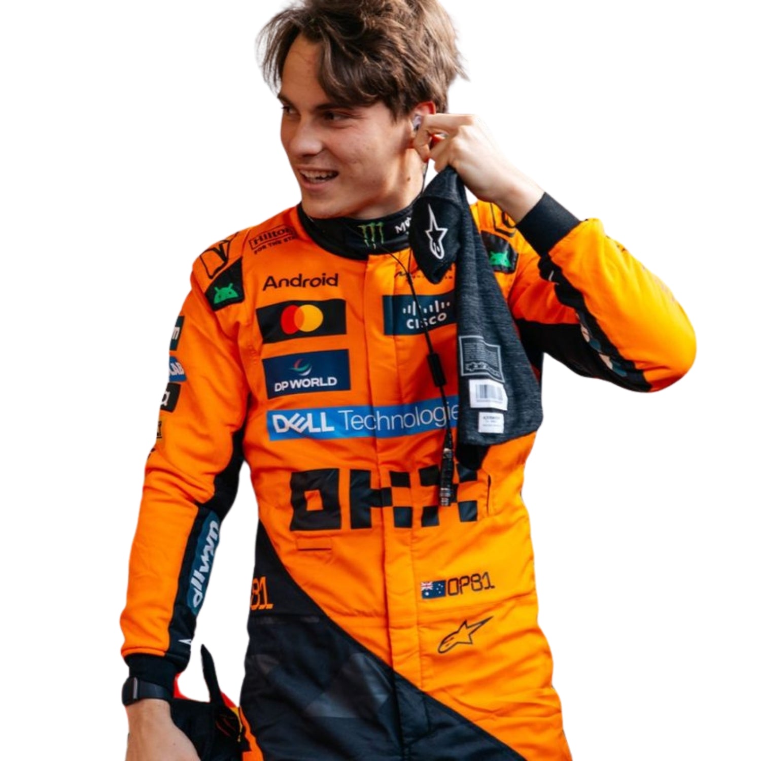 Oscar Piastri in the 2025 F1 racing suit walking through the pit lane, highlighting the suit's bold colors and fitted look.

