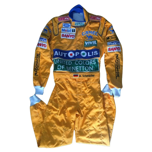 Front view of Michael Schumacher’s 1991 Camel F1 race suit, yellow and blue livery with bold Camel branding and stitched sponsor logos.