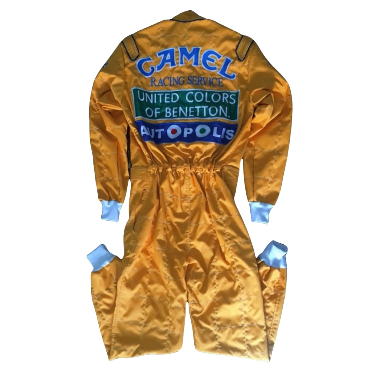 Back view of Schumacher’s 1991 Benetton Ford F1 suit, featuring Camel branding, bright yellow base, and race-stitched team insignia.
