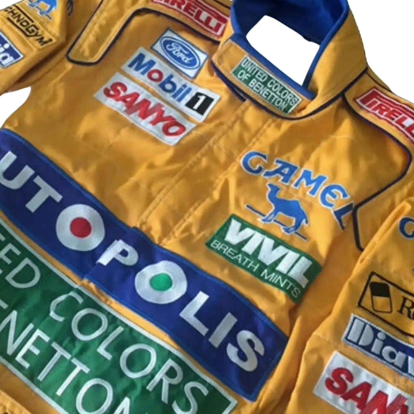Close-up detail of the upper chest and shoulder area of the 1991 Benetton Ford suit, showing Camel logo embroidery and driver patch.