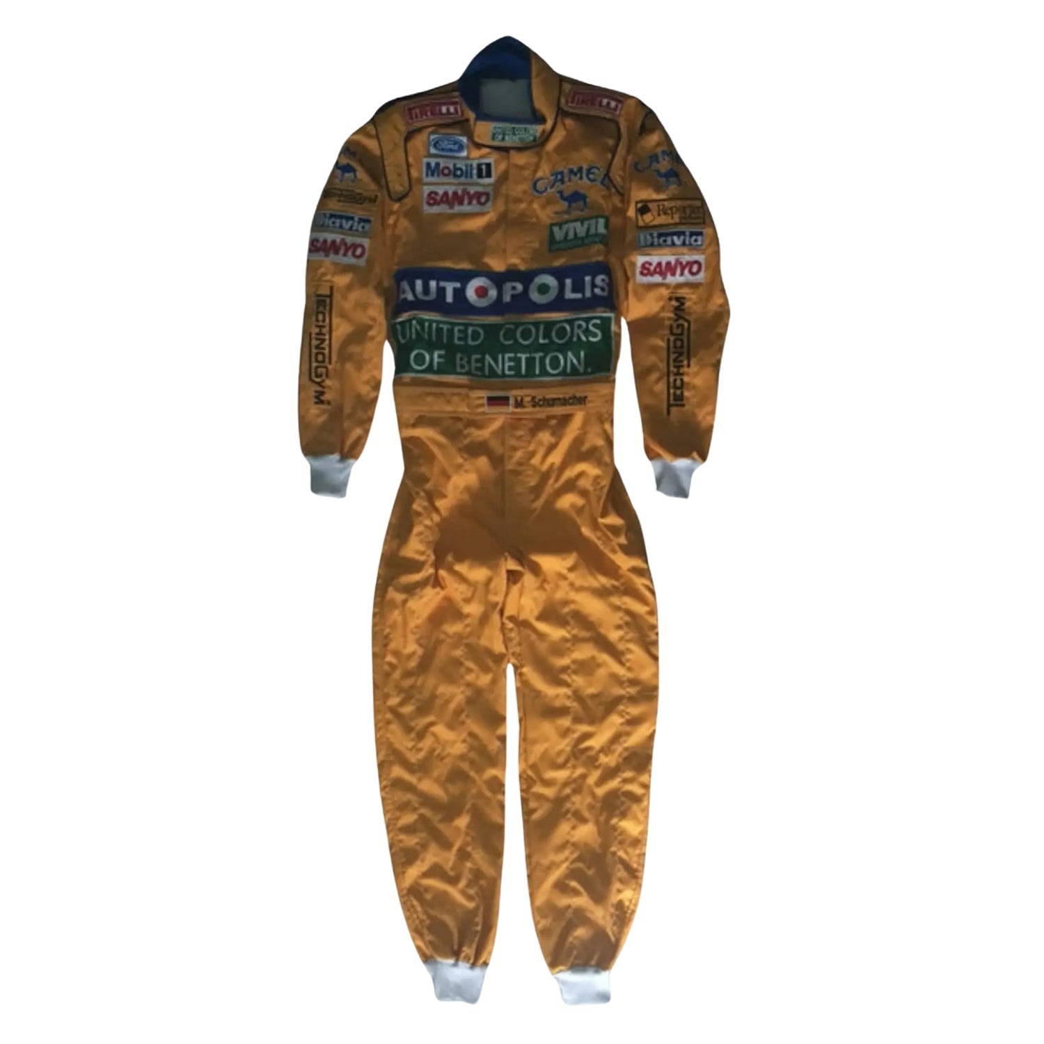 Front view of Michael Schumacher’s 1991 Camel F1 race suit, yellow and blue livery with bold Camel branding and stitched sponsor logos.