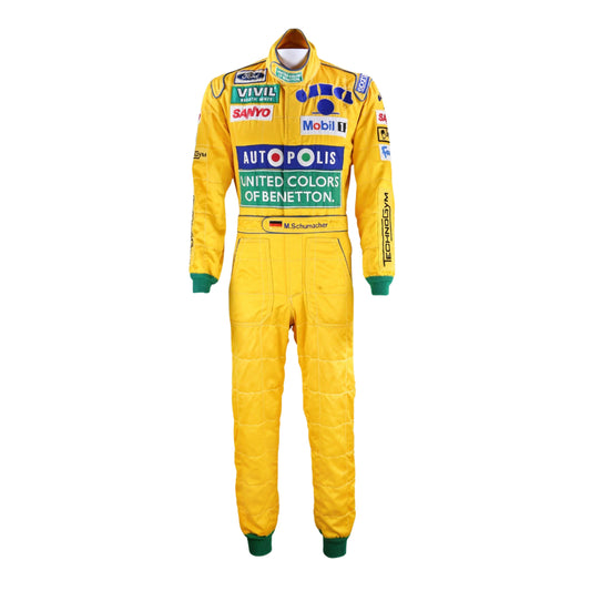Front view of Michael Schumacher's 1992 F1 racing suit featuring deep green with yellow accents, signature Benetton sponsorship, and classic zip-front design.