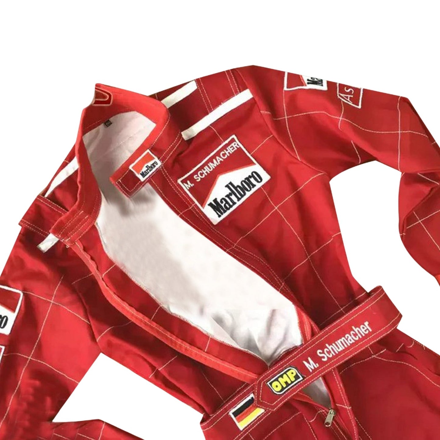 Close-up of Schumacher’s 1996 F1 suit, featuring the detailed stitching, Ferrari red color, and early sponsor branding from his debut season