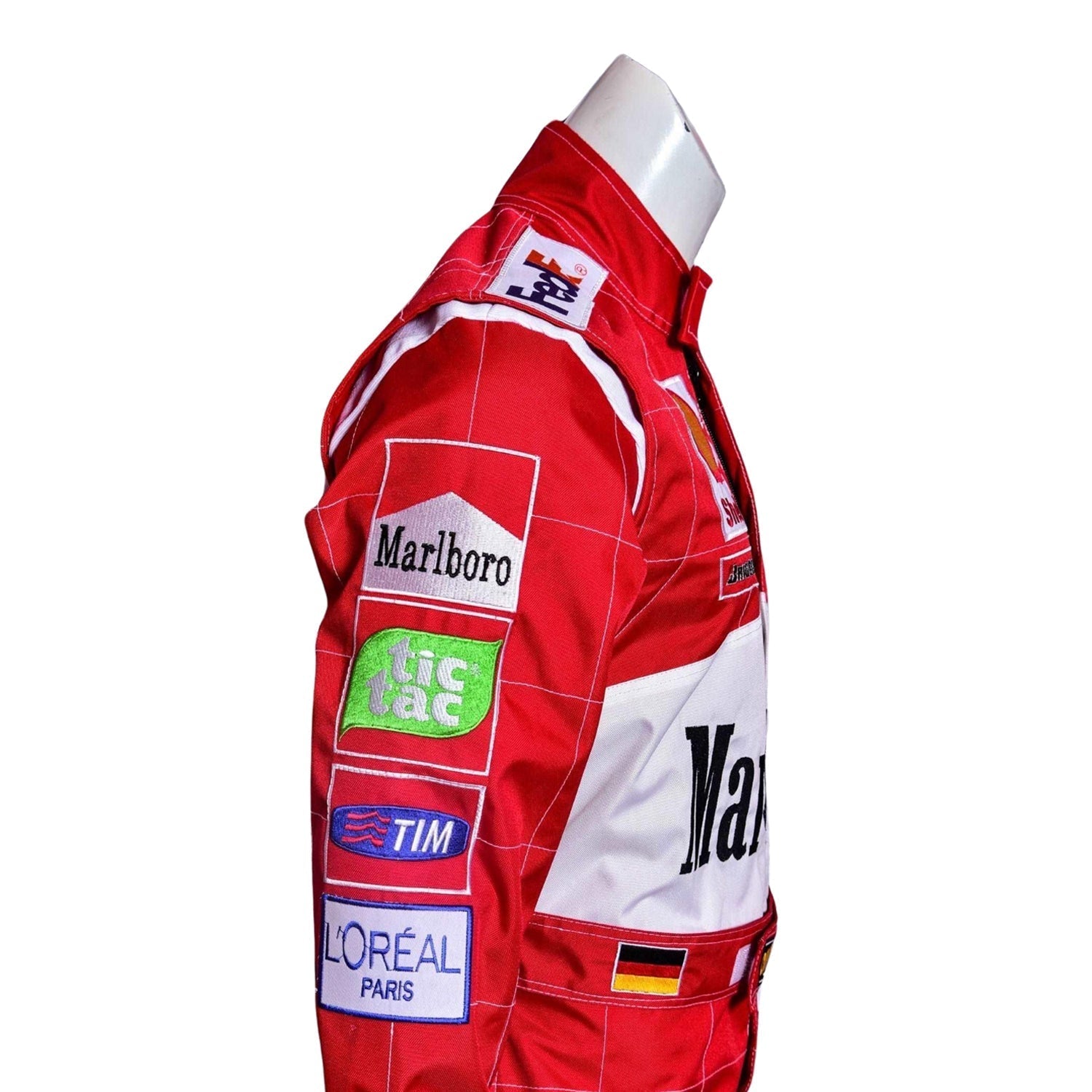 Side angle of the 2001 Schumacher F1 suit showing curved seam design, yellow accents on arms, and racing sponsor logos.