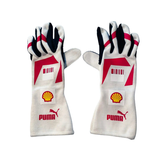 Pair of white Michael Schumacher 2007 F1 racing gloves with red and black accents featuring Puma and Shell logos on a white background.
