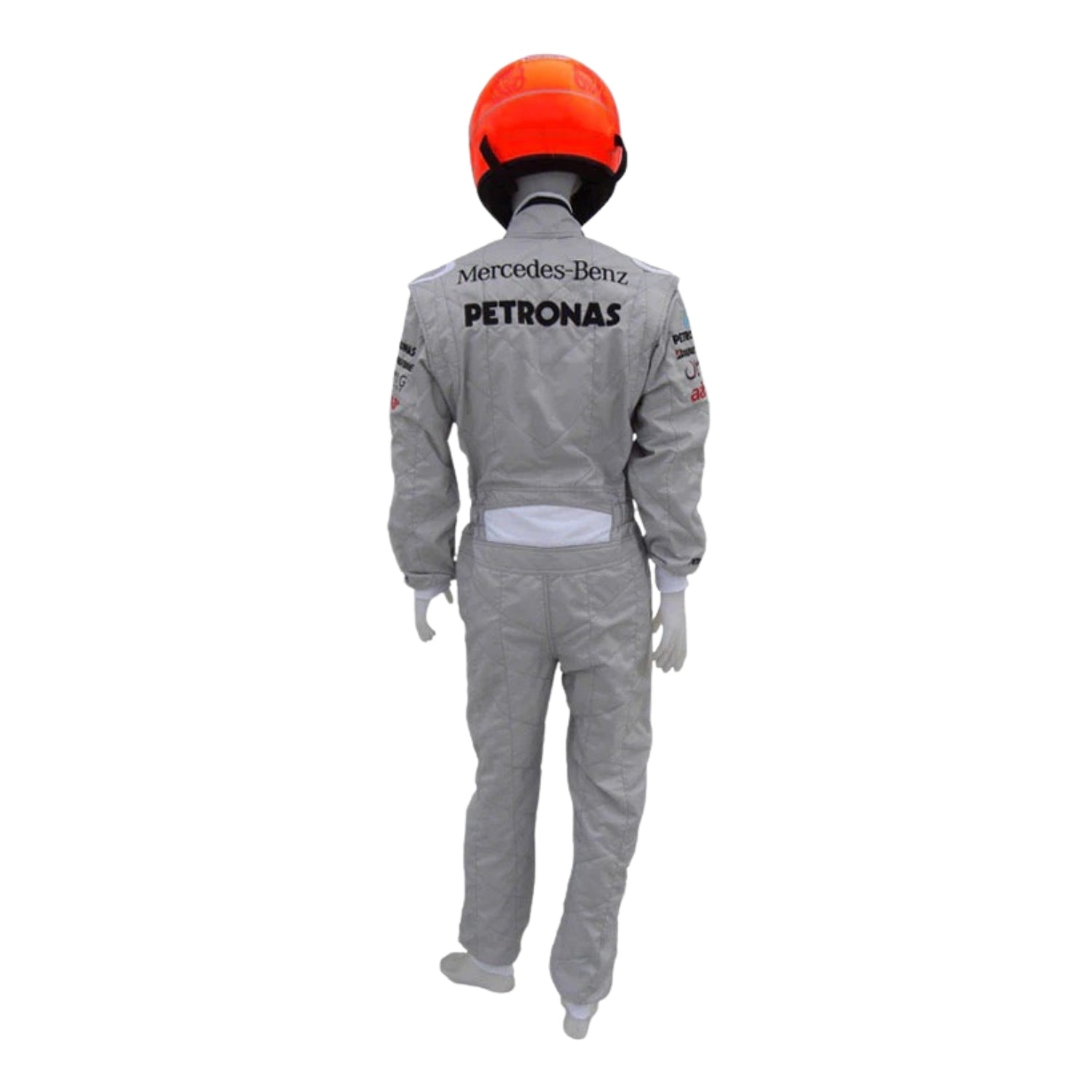 Rear view of Schumacher’s 2010 F1 suit, showcasing silver base with streamlined panels and embroidered name detailing.