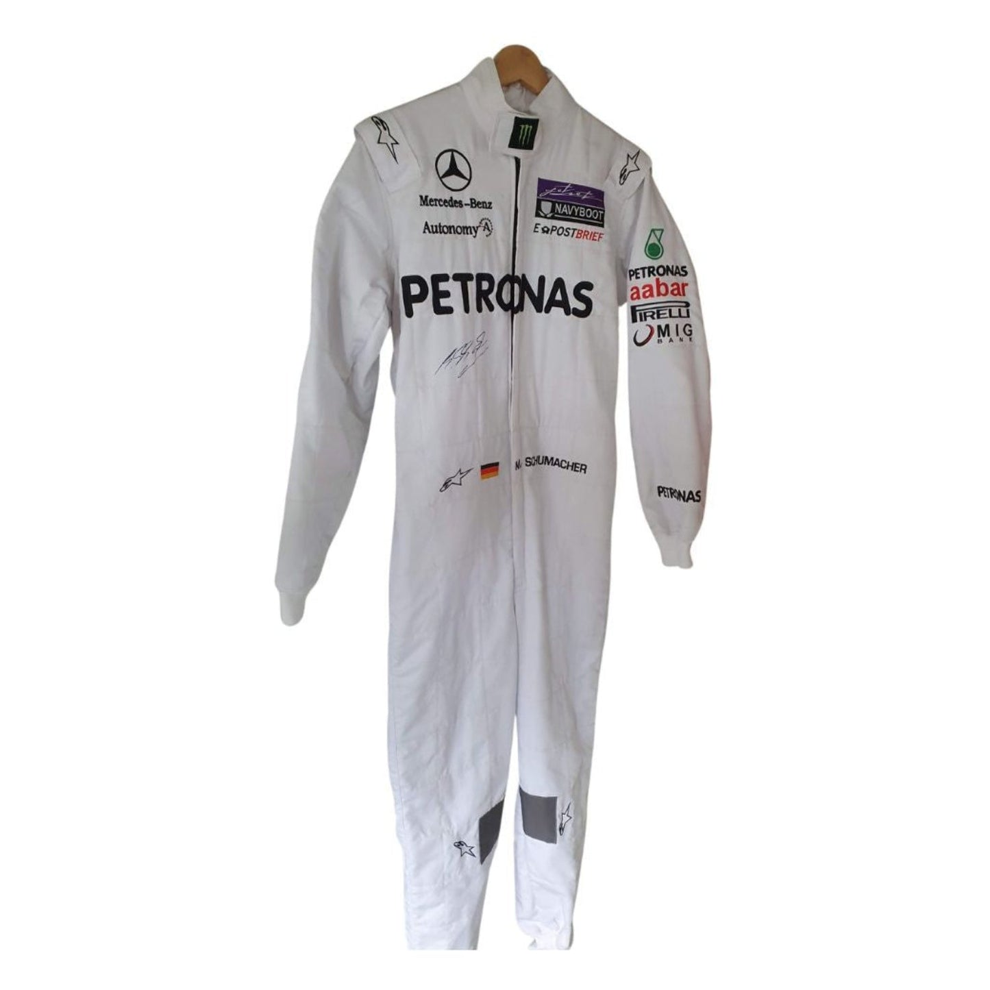 Front view of Michael Schumacher’s 2011 F1 racing suit in silver with green highlights, showcasing sponsor patches, front zip, and signature detailing.
