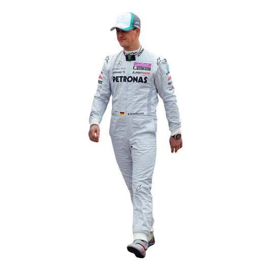 Front view of Michael Schumacher’s 2011 F1 racing suit in silver with green highlights, showcasing sponsor patches, front zip, and signature detailing.
