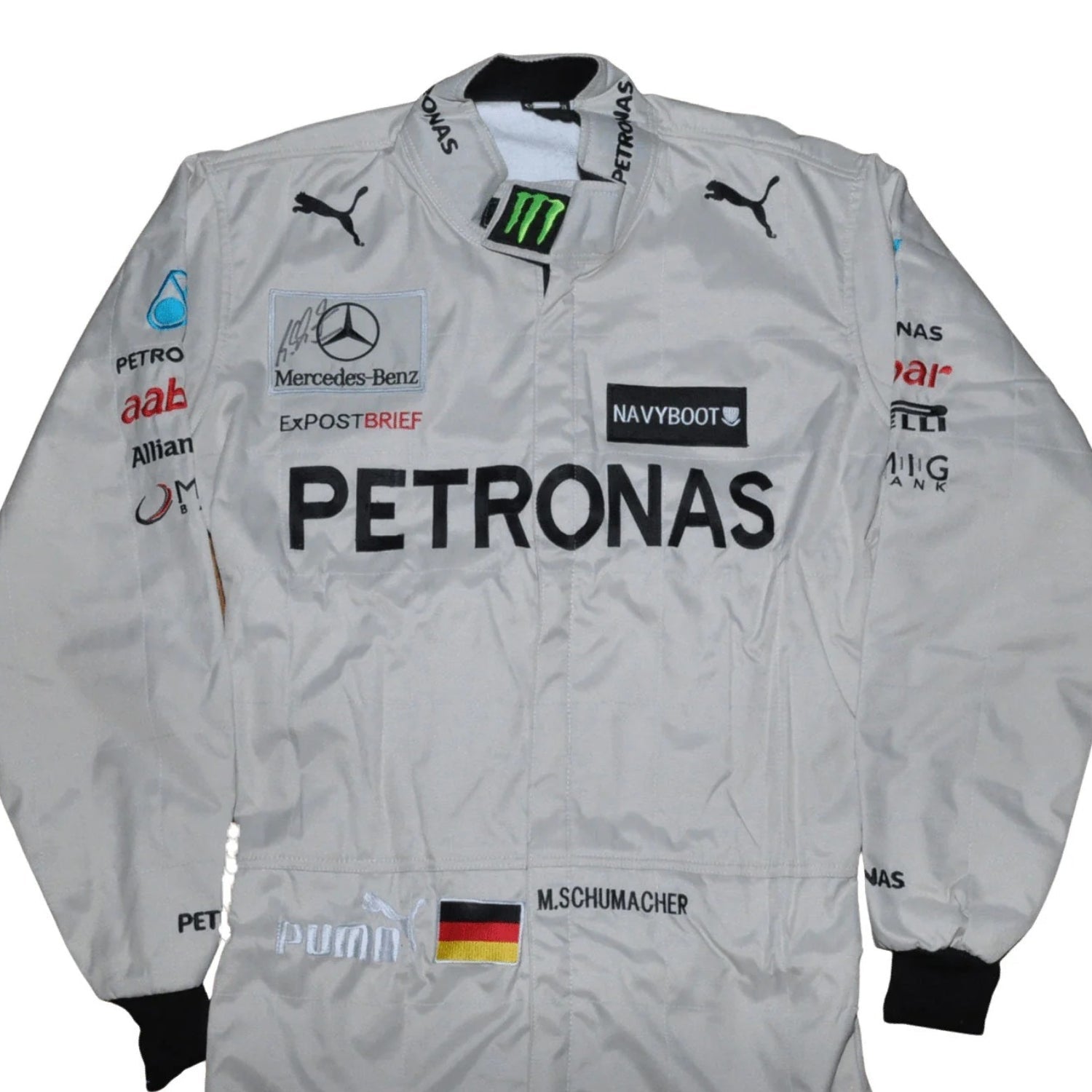 Close-up of the name embroidery and chest sponsor area on Schumacher’s 2012 racing suit, highlighting the stitching and race-worn textures.