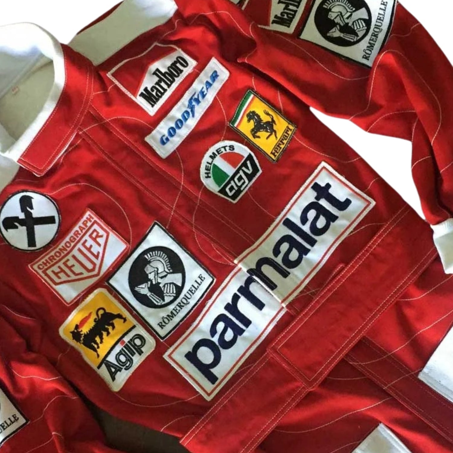 Close-up of Niki Lauda’s 1976 racing suit detailing, capturing the fine craftsmanship of Ferrari’s design and the sponsor logos, a testament to his legendary comeback.