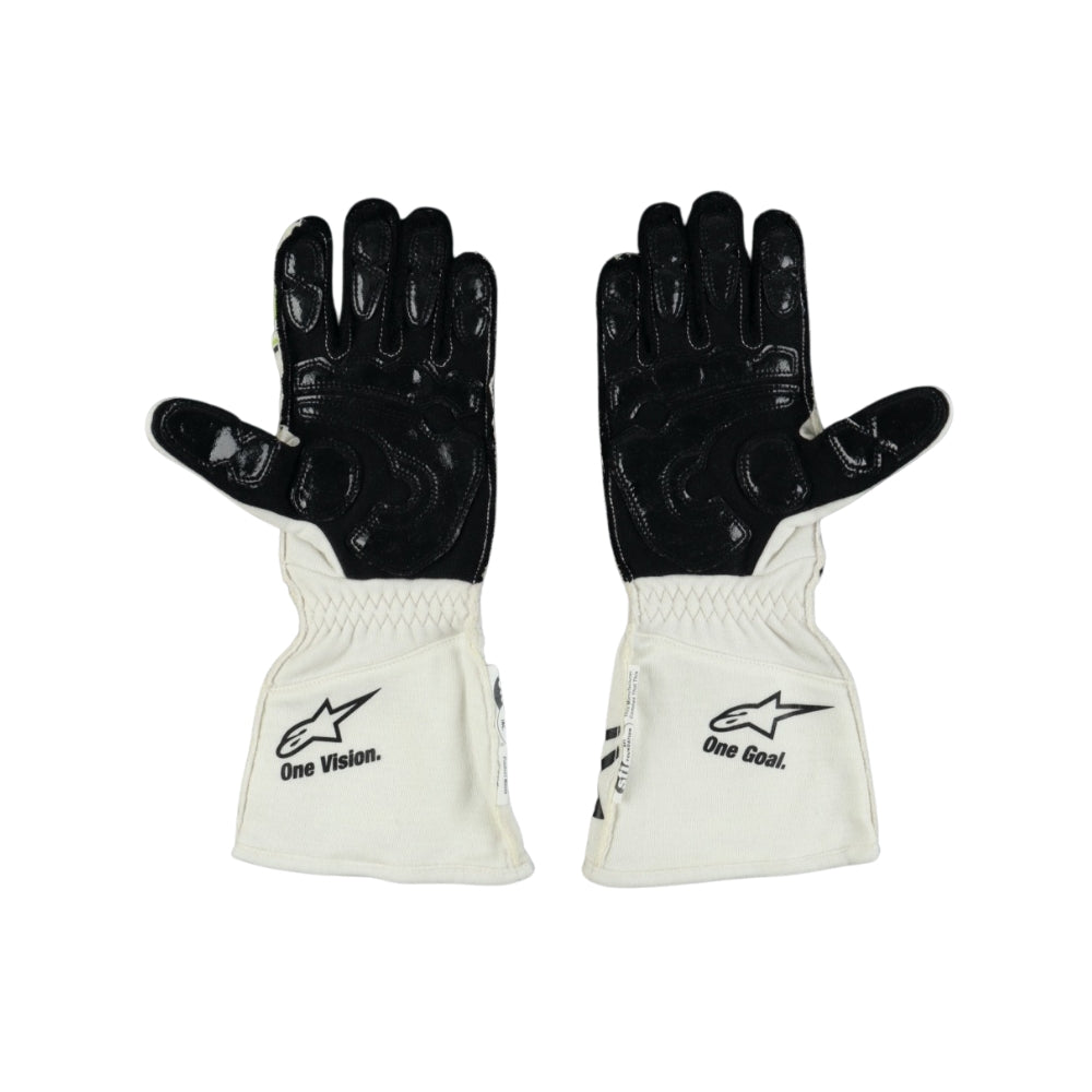 Pair of black and white Nyck de Vries 2022 F1 racing gloves with visible branding on a white background
