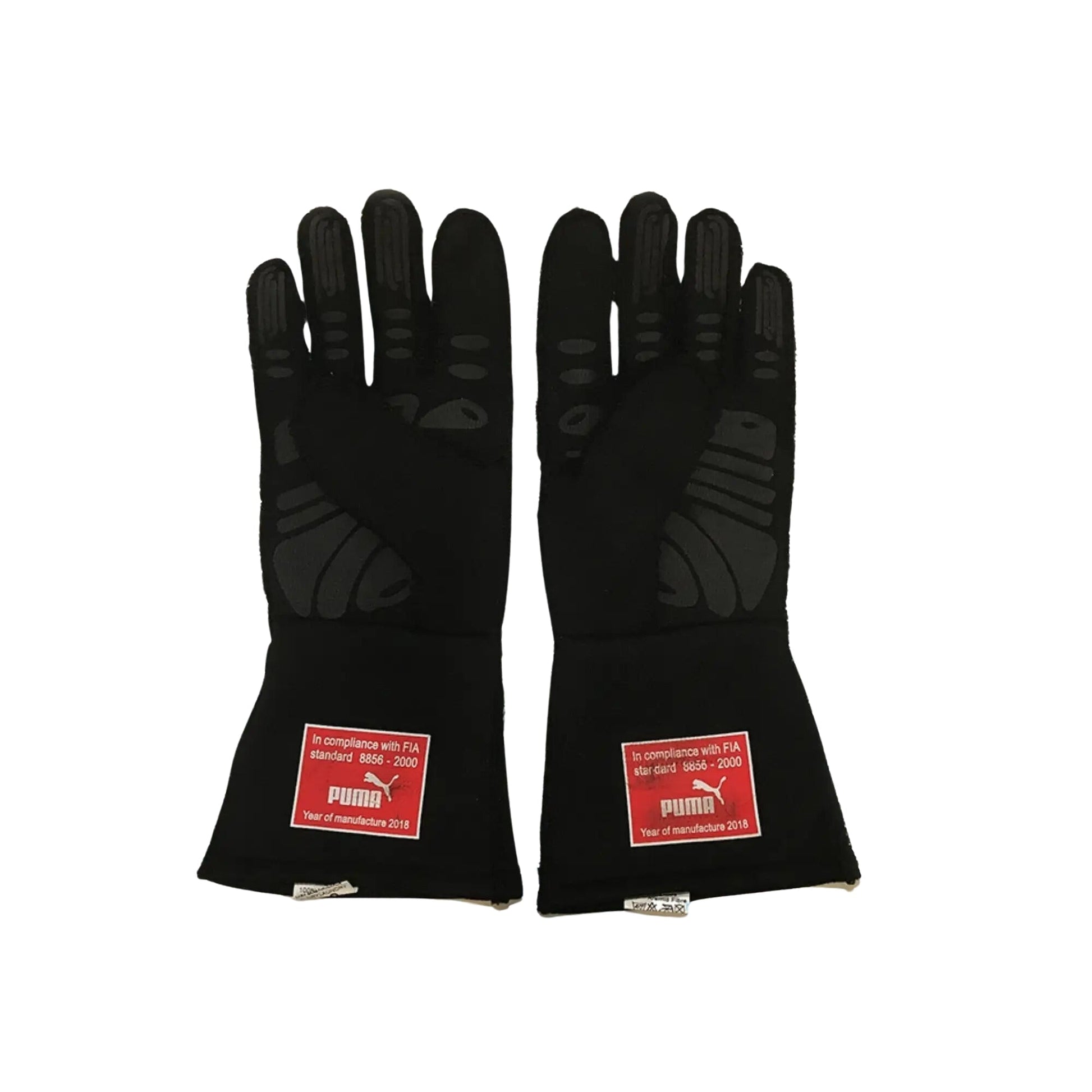 Pair of black Sebastian Vettel 2018 F1 racing gloves with FIA compliance labels on a white background