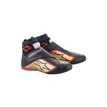 Black and gold Supermono v2 racing shoes with red accents on a white background