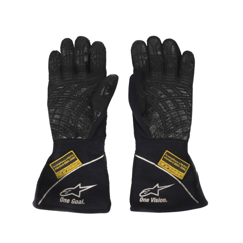 Pair of Valtteri Bottas 2015 black gloves with visible branding on a white background