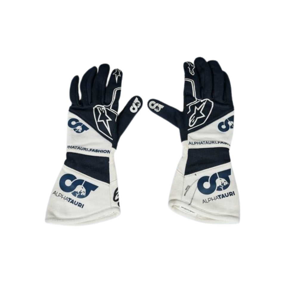 Pair of black and white Yuki Tsunoda 2022 F1 Racing gloves with branding on a white background